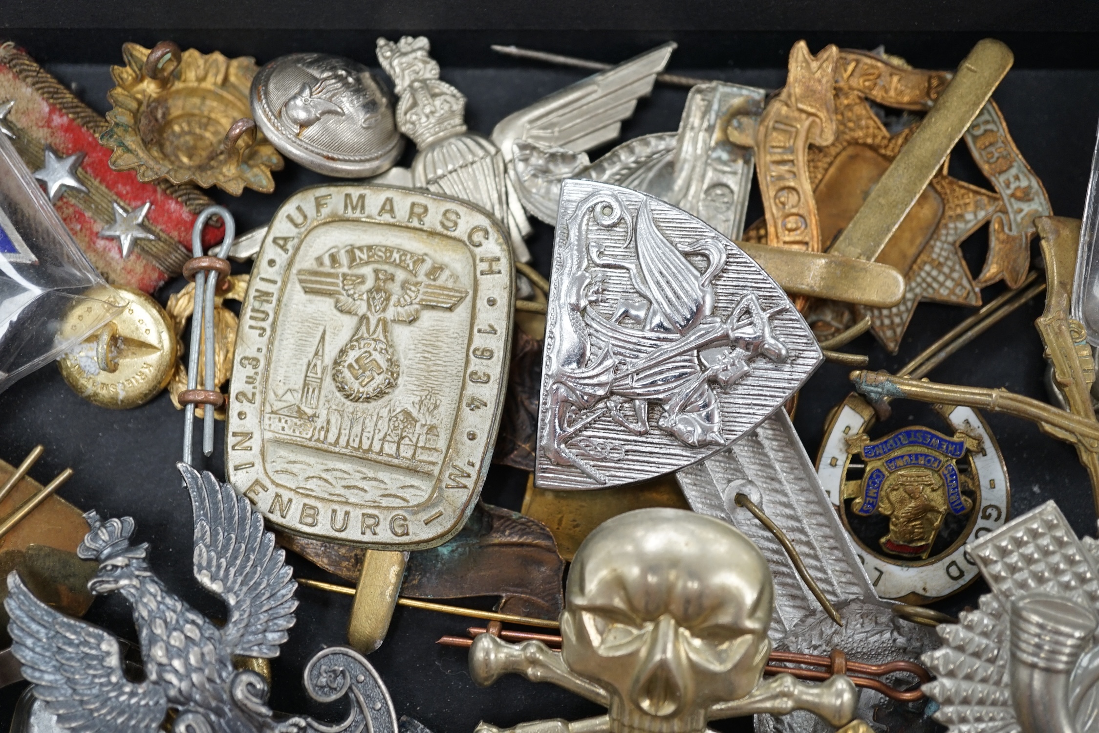 A collection of military cap badges and medals, including a First World War medal pair awarded to A.M. F.W. Wright, together with seventeen British and German cap badges including; the West Yorkshire Regiment, the Royal